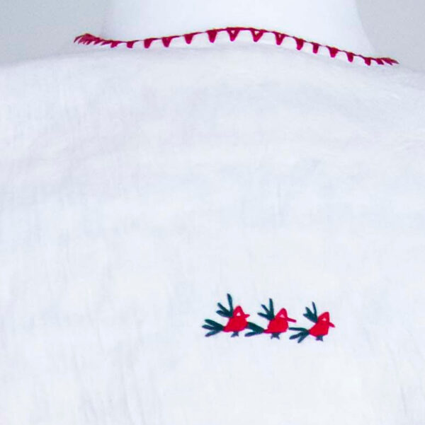 Traditional handmade Mexican embroidered white blouse made of cotton detail back view