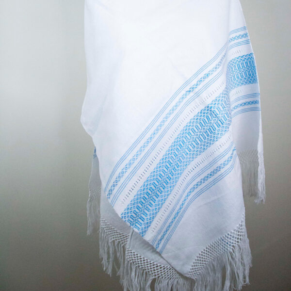 Front view of a Traditional Handwoven Mexican White and blue Shawl Scarf Wrap made of cotton on a mannequin