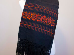 Front view of a Traditional Handwoven Mexican black and orange Shawl Scarf Wrap made of cotton on a mannequin